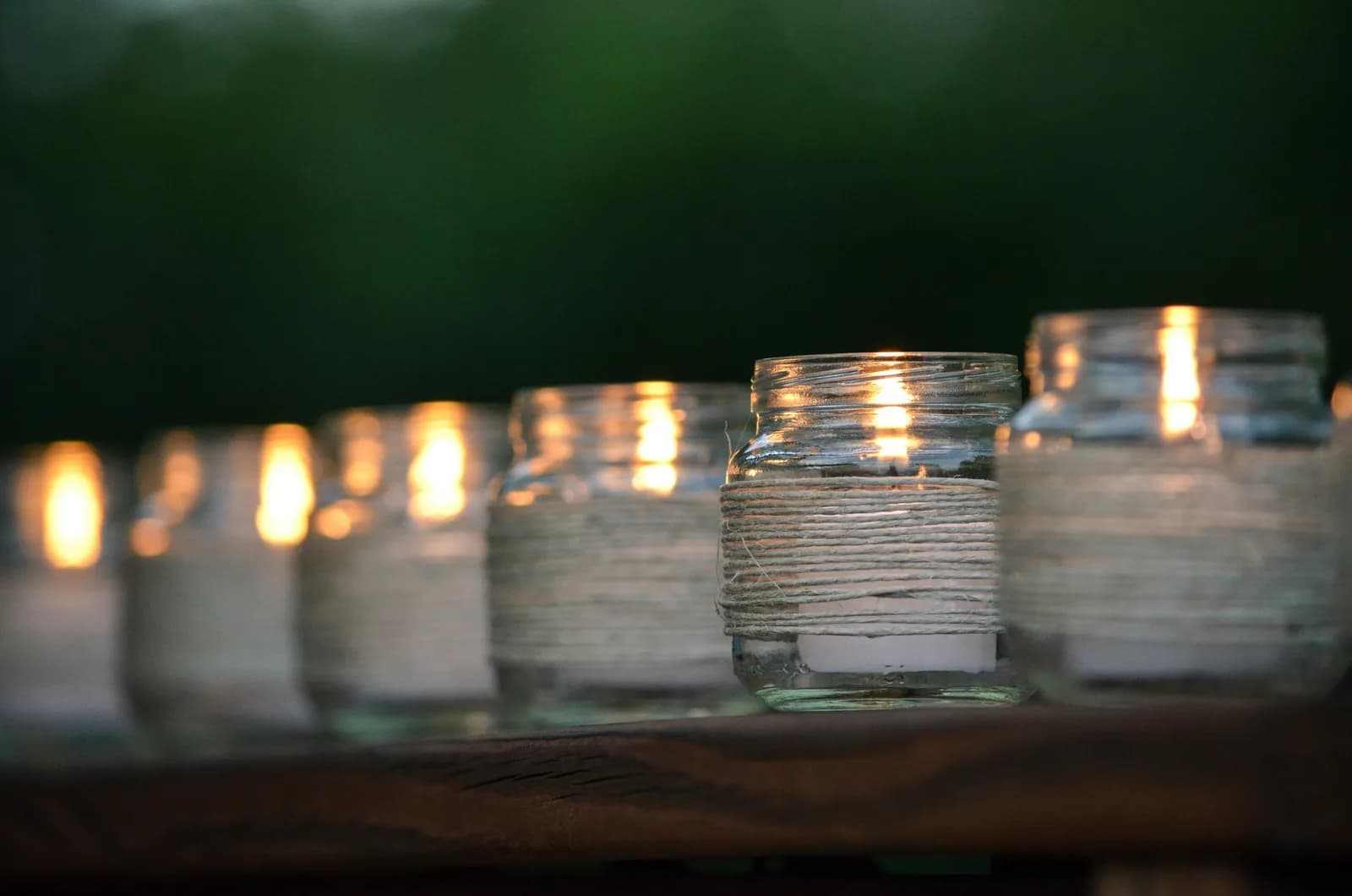 Scented candle with warm flickering flame in cozy setting