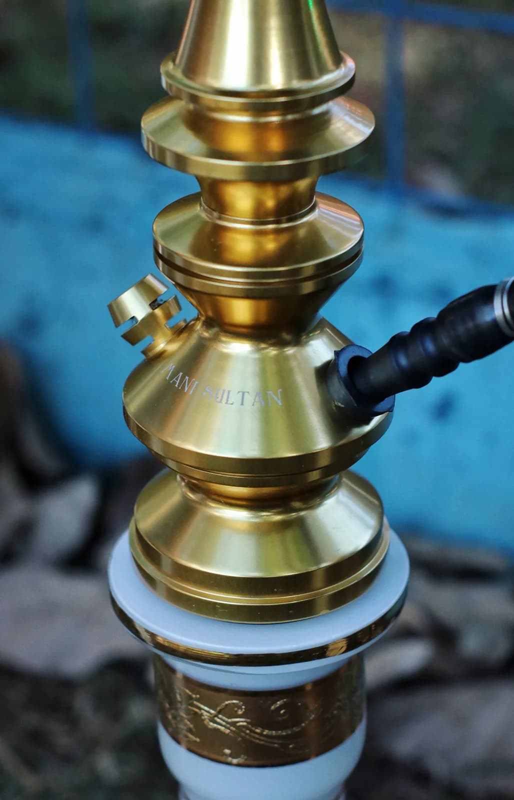 Traditional hookah pipe with aromatic smoke in ambient light