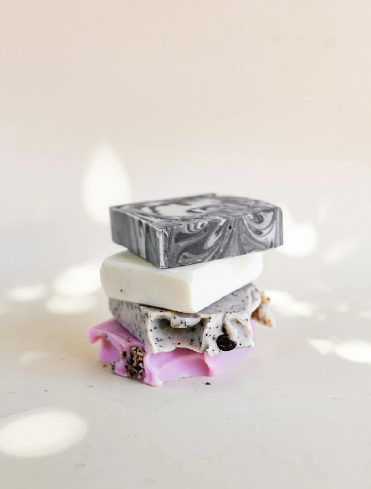 Artisan bar soap with botanicals on stone surface