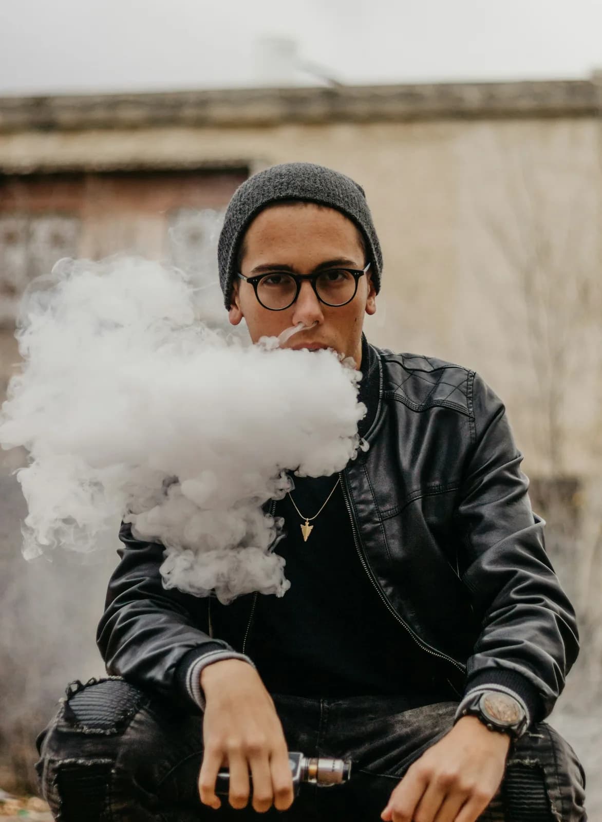 Vape device and e-liquid bottles on a dark surface